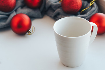 Empty white mug on the background of christmas tree decorations