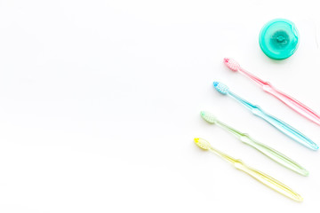 Clean teeth. Colorful plastic toothbrushes on white background top view space for text