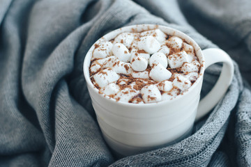 Cocoa with marshmallows on a cozy gray background