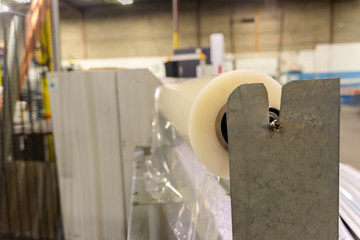 Roll of plastic wrapping material in factory workshop packaging