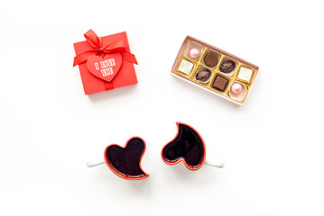 Valentine's day concept. Sweets, red gift box, heart-shaped mugs on white background top view copy space
