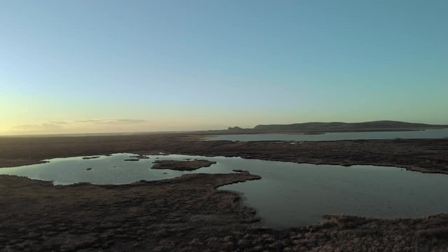 Aerial Drone flight over Loch Gorm located on the Isle of Islay, Hebrides, Scotland next to the Kilchoman Rockside Farm Whisky Distillery.