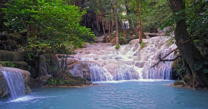 Emerald pool in wilderness of jungle forest. Tropical waterfall in rainforest environment