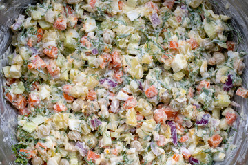 Healthy homemade russian traditional salad olivier ready to eat, close up