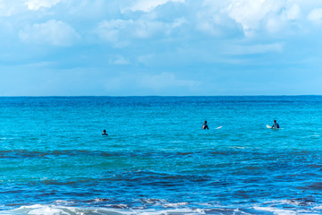 Fototapeta na wymiar indistinct Surfers in the Blue Mediterranean Sea