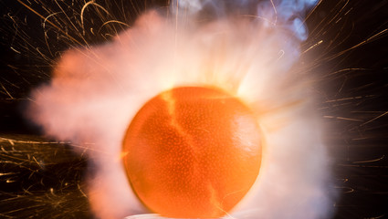 The explosion of fruit, flash and smoke, apple, lemon, orange