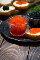 traditional red and black caviar and sandwiches on plate, vertical