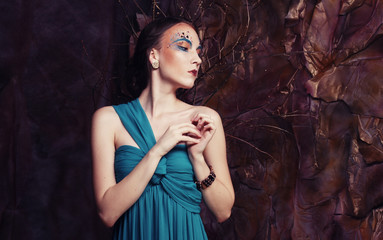 elegant sensual young woman in blue dress