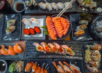 Salmon sashimi and other seafood and sushi on the party table