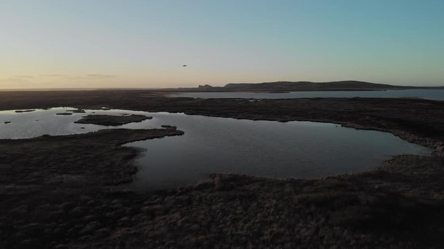 Aerial Drone flight over Loch Gorm located on the Isle of Islay, Hebrides, Scotland next to the Kilchoman Rockside Farm Whisky Distillery.
