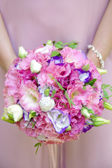 Beautiful wedding bouquet in hands of the bride. Wedding concept