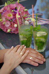 Hands of the bride and groom with gold wedding rings. Wedding concept.