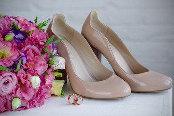 Wedding shoes and wedding paraphernalia, wedding bouquet, wedding gold rings. 