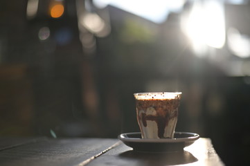 Coffee fusion cream milk and toping green tea with a morning light on wood table.