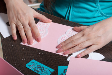 Obraz premium Making greeting cards from paper, cardboard and tape. Woman artisan at work.
