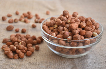 Hazelnuts in a transparent bowl on the table