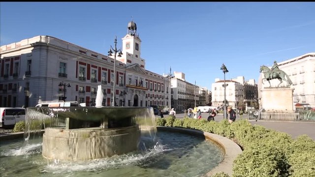 Fountain and architecture in early morning sunshine on Puerta del Sol, Madrid, Spain, Europe