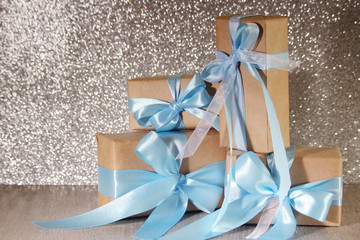 Wrapped gifts at silver background
