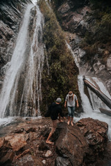 couple under waterfall
