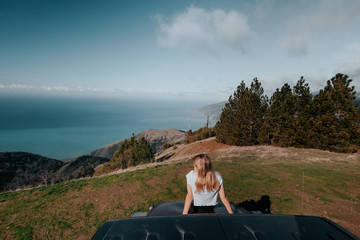 woman on top of car