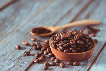 Coffee beans on wooden texture and background, using color grading effect