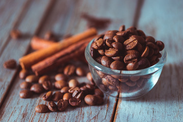 Coffee beans on wooden texture and background, using color grading effect