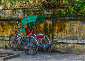Fototapeta na wymiar Cyclo (rickshaw) on street in Hoi An, Vietnam