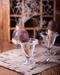 chocolate ice cream in cone on dark background with blank space