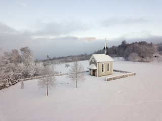 Winter Switzerland fairytale chapel on hill 