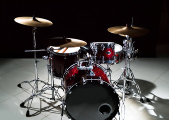 Fototapeta na wymiar Professional drum set on stage on the black background 