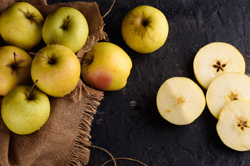 Ripe appetizing apples with burlap. Cinnamon, apples, burlap, table, knife. Fruits.