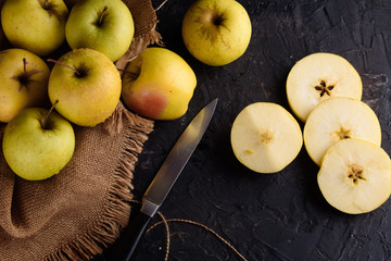 Ripe appetizing apples with burlap. Cinnamon, apples, burlap, table, knife. Fruits.
