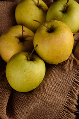Ripe appetizing apples with burlap. Cinnamon, apples, burlap, table, knife. Fruits.