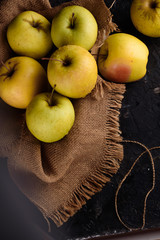 Ripe appetizing apples with burlap. Cinnamon, apples, burlap, table, knife. Fruits.