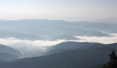 Fototapeta na wymiar Mist in Beskid Sadecki. View from Jaworzyna Mount toward South, Krynica-Zdroj, Poland. 