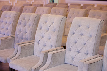 Fototapeta premium A range of a large number of soft comfortable grey armchairs.