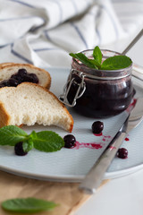 .bread, berry jam. and mint on white background