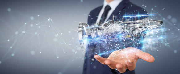 Businessman using wireframe holographic 3D digital projection of an engine