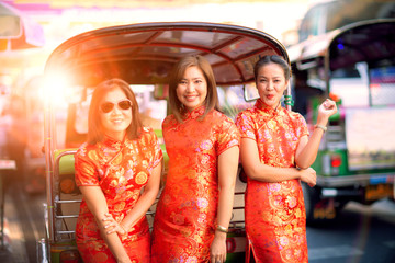 three asian woman wearing chinese tradition clothes in yaowarat street bangkok thailand