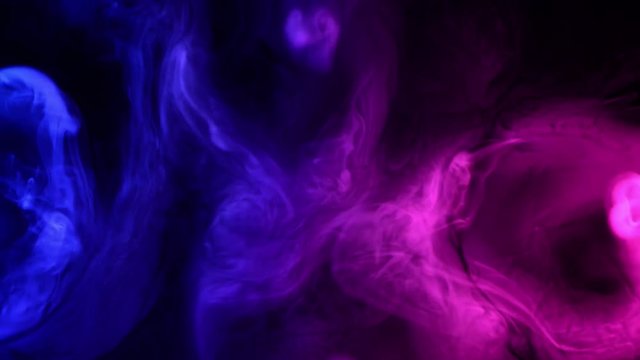 abstract red and blue smoke waves at dark background 