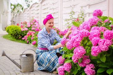 Fototapeta na wymiar hydrangea. Spring and summer. Flower care and watering. soils and fertilizers. woman care of flowers in garden. happy woman gardener with flowers. Greenhouse flowers. Working with plants