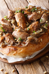 Palestinian cuisine of Musakhan with flat bread taboon close-up on the table. vertical