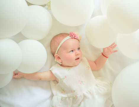 Little Baby. Family. Child Care. Childrens Day. Small Girl. Happy Birthday. Sweet Little Baby. New Life And Birth. Portrait Of Happy Little Child In White Balloons. Childhood Happiness