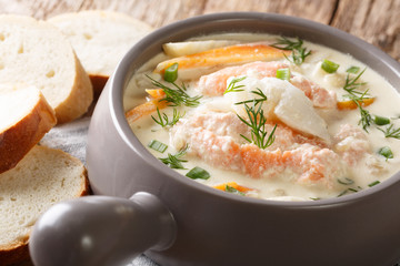 Closeup of Scandinavian cream fish soup with cod, salmon and vegetables in a bowl served with fresh...