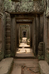 Fototapeta na wymiar View through stone corridor in ruined temple