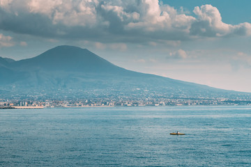 Naples, Italy. Man Training On Kayak In Tyrrhenian Sea. Landscape With Volcano Mount Vesuvius And Tyrrhenian Sea In Sunny Summer Day