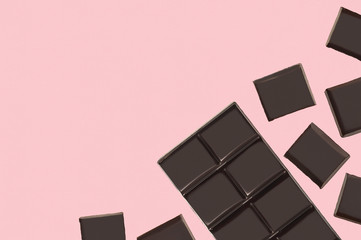 Bars of chocolate on a pink background