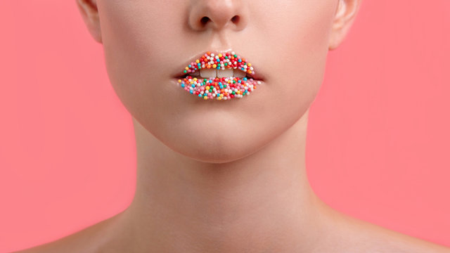 Close up view of female lips with sweet donut makeup. Fashion make up, dessert or junk food concept. Creative makeup