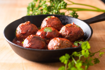 Food Homemade organic spicy meatball in iron cast on wooden background