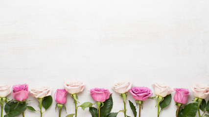 Flowers valentine day composition. Frame made of pink rose on gray background. Flat lay, top view,...